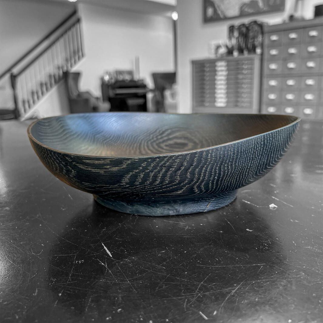 Ebonized oak bowl on a black table