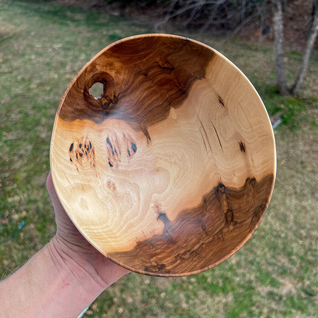 Walnut wobble bowl with knot hole