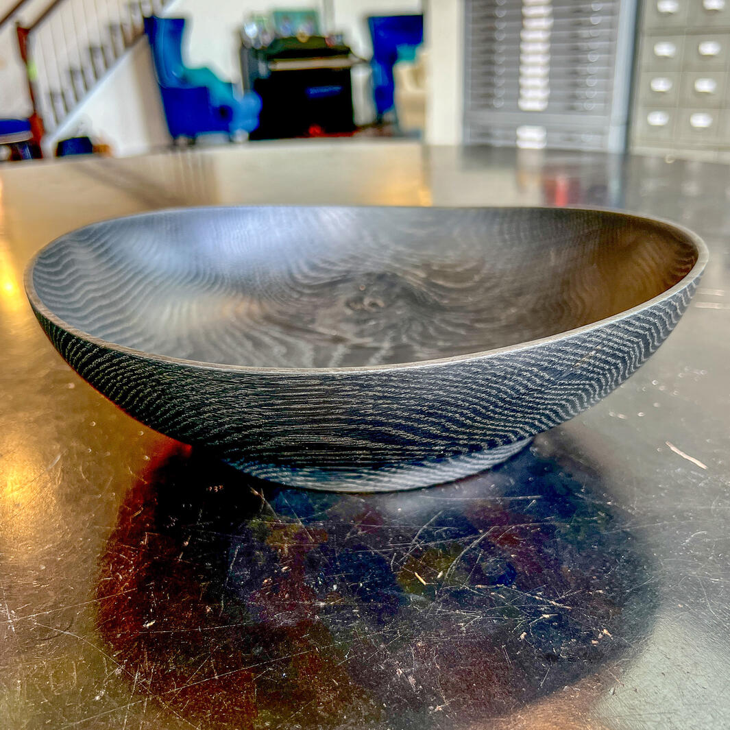 Ebonized oak bowl on a black table