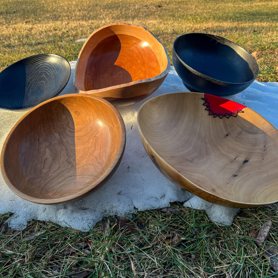 wooden bowls on a small snowy mound